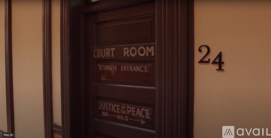 A brown door with a sign that says Court Room.