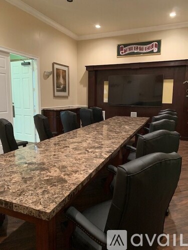 A conference room with a long table and chairs.