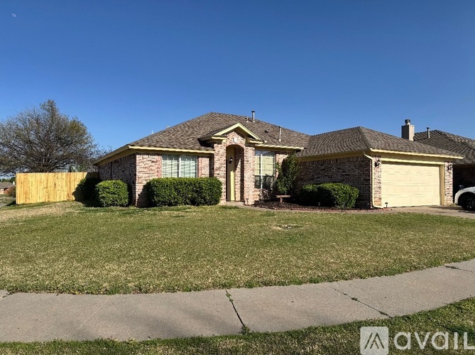 A house with a brown roof and a white garage door.