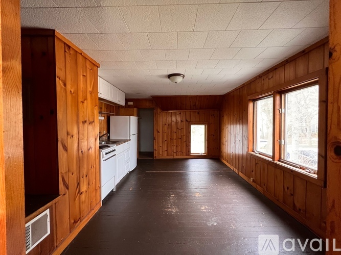 A kitchen with wooden cabinets and a white refrigerator.