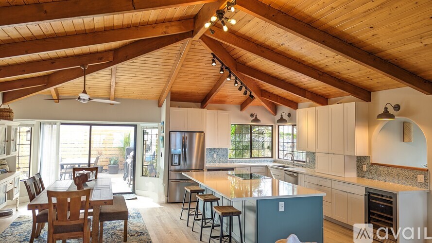 A kitchen with a dining table and chairs.