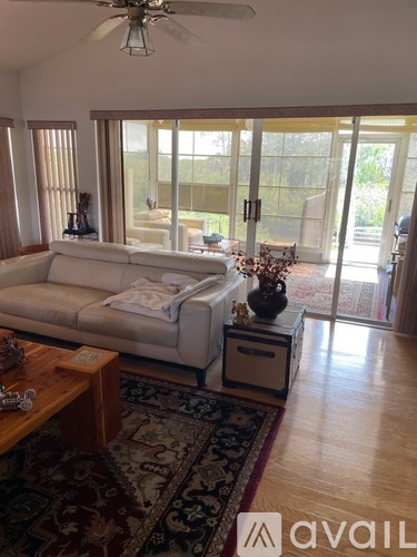 A living room with a white couch and a coffee table.