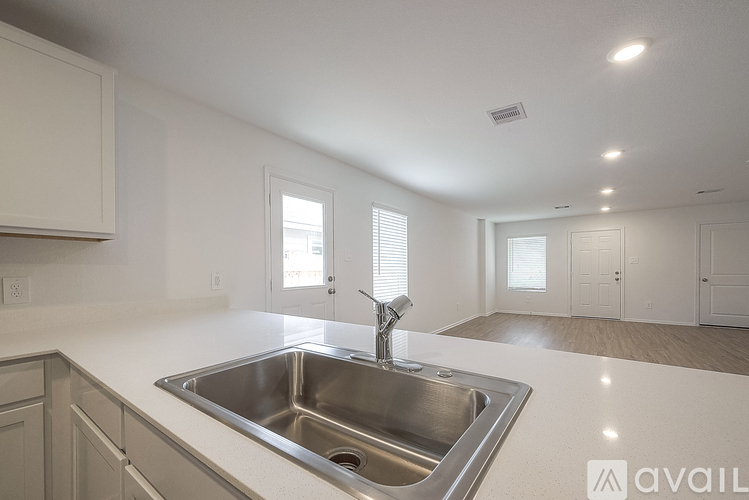A kitchen with a sink and a window.