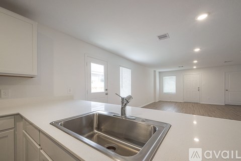 A kitchen with a sink and a window.