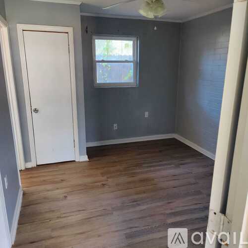 A room with a white door and a window.