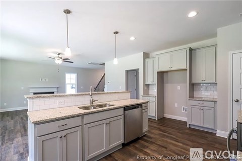 A kitchen with a sink and a stove top oven.