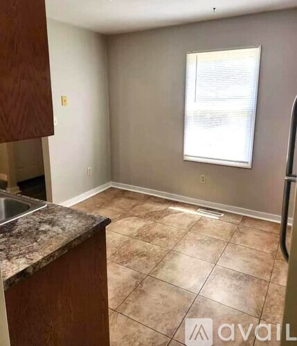 A kitchen with a sink and a window.