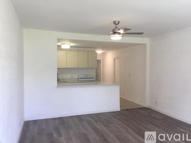 A room with a ceiling fan and a wall-mounted air conditioner unit.