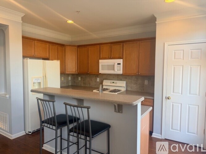 A kitchen with wooden cabinets and a white refrigerator.