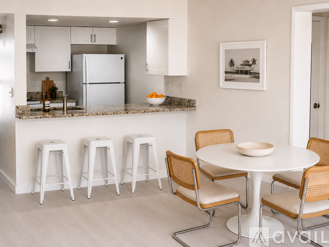 A kitchen with a marble countertop and a sink.