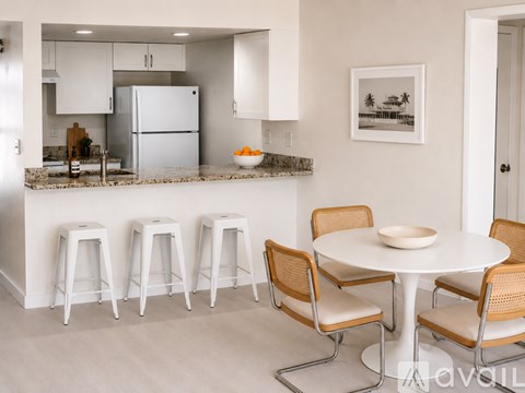 A kitchen with a marble countertop and a sink.