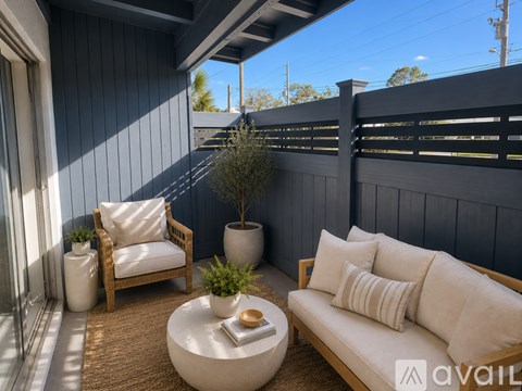 A pool with a black fence and a blue sky in the background.