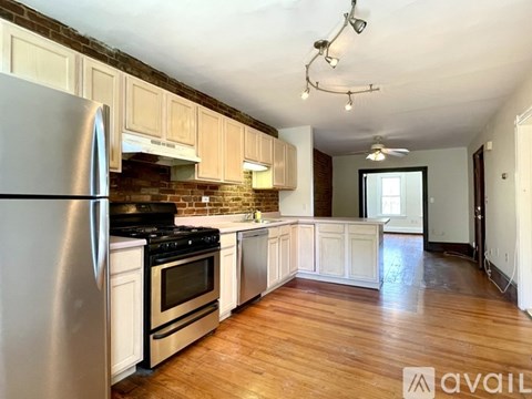 A kitchen with a refrigerator, stove, and oven.