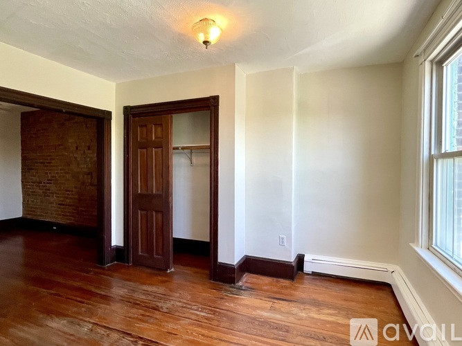 A room with wooden floors and a door.