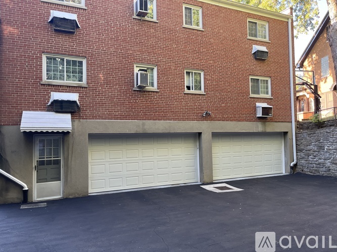 A red brick building with a white garage door.