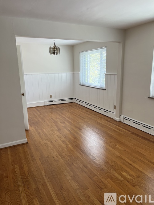A room with wooden floors and white walls.
