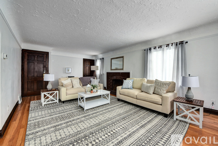 A living room with a rug, two couches, and a coffee table.