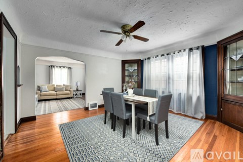A dining room with a table set for four.