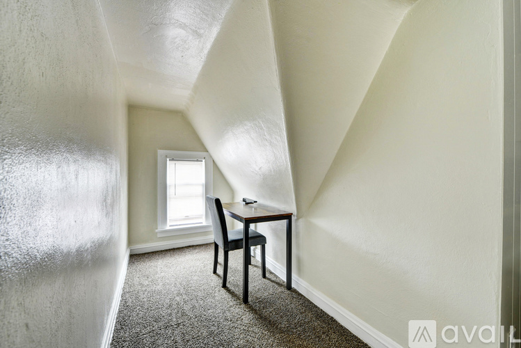 A room with a table and a chair in it.