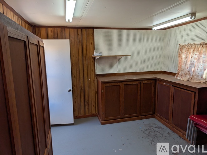 A room with wooden walls and a white door.