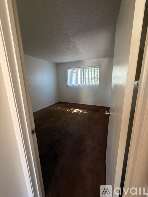 A room with a window and a door.
