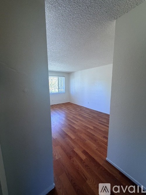 A room with wooden floors and white walls.