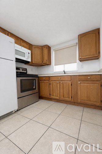 A kitchen with wooden cabinets and a white refrigerator.