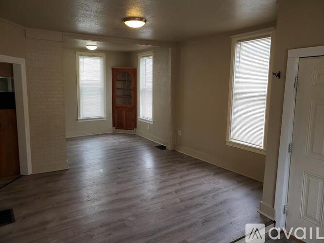 A room with wooden floors and a white door.