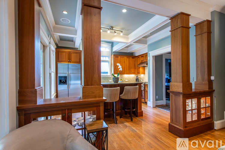 A modern kitchen with wooden cabinets and a center island.