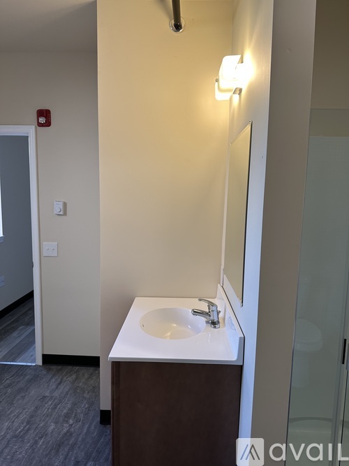 A bathroom with a sink and mirror.