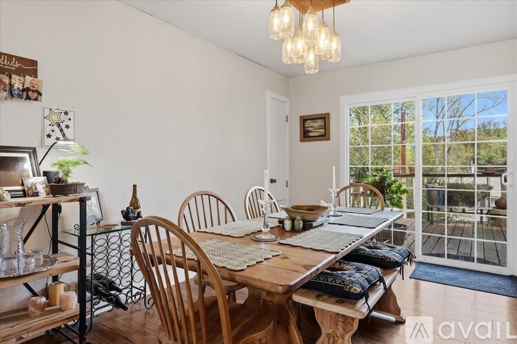 A dining room with a wooden table and chairs.