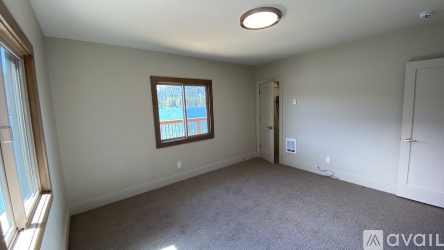 A room with a window and a door is available for rent.