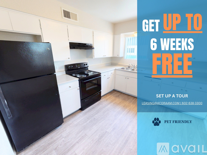 A kitchen with a black fridge and a sign offering 6 weeks free.