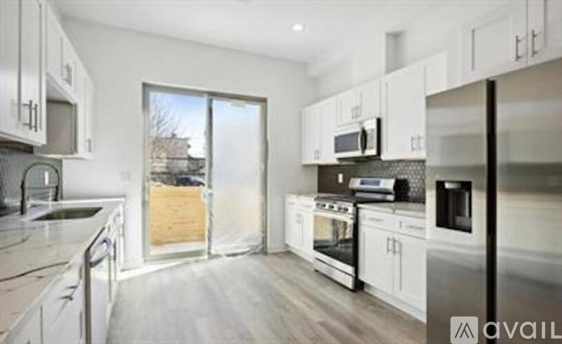 A kitchen with white cabinets and stainless steel appliances.