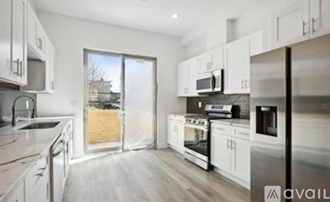 A kitchen with white cabinets and stainless steel appliances.