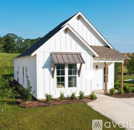 A white house with a black circle on it.