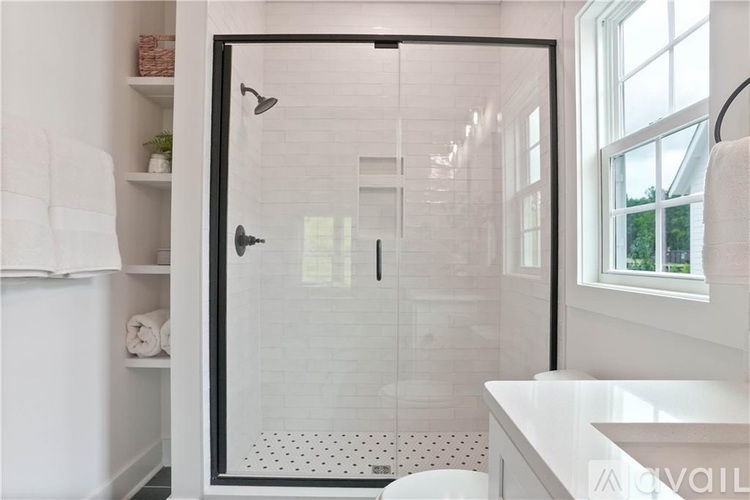 A white bathroom with a walk-in shower.
