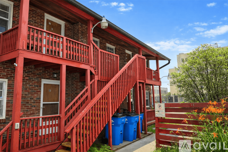 A red building with a staircase leading to the second floor.