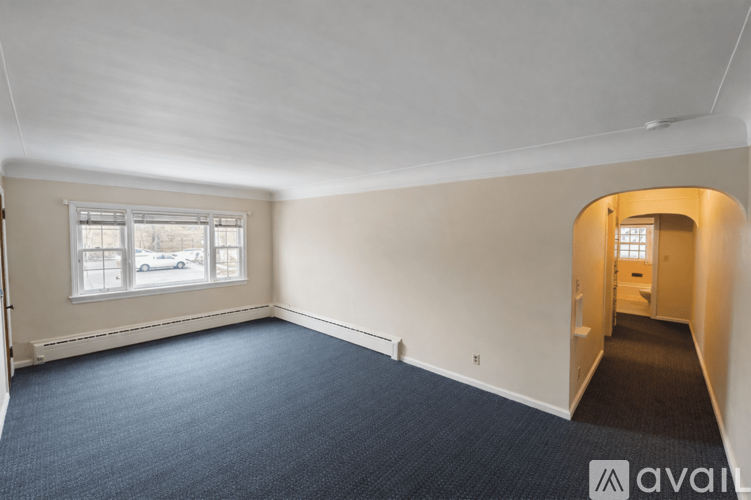A room with a car parked outside the window.