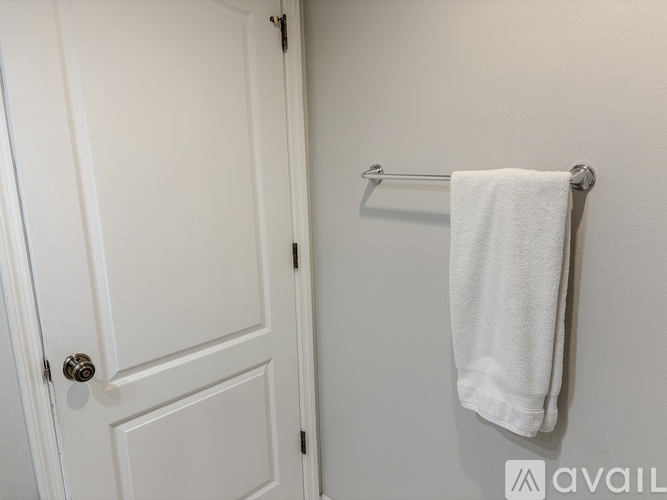 A white towel is hanging on a towel rack.