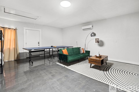 A living room with a green couch and a coffee table.