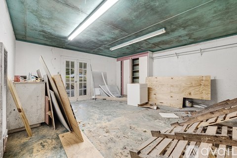 A room with a lot of debris and unfinished walls.