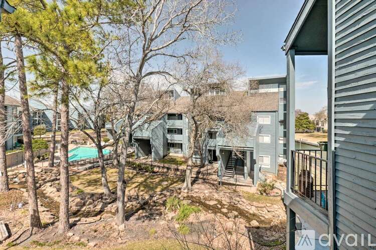 A house with a pool surrounded by trees.