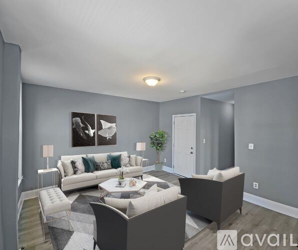A living room with a grey couch and a coffee table.