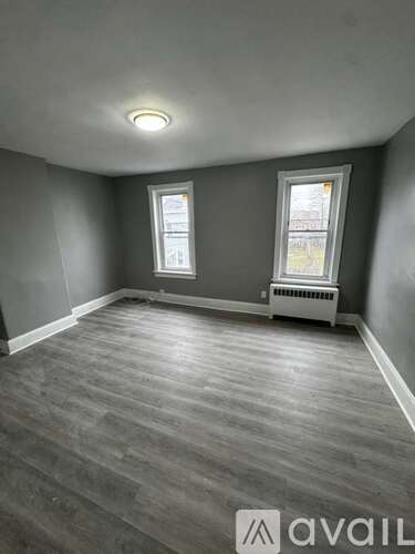 A room with grey walls and a wooden floor.