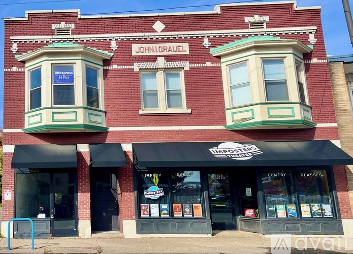 A red building with a sign that says John Gravel on it.