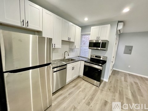 A kitchen with white cabinets and stainless steel appliances.