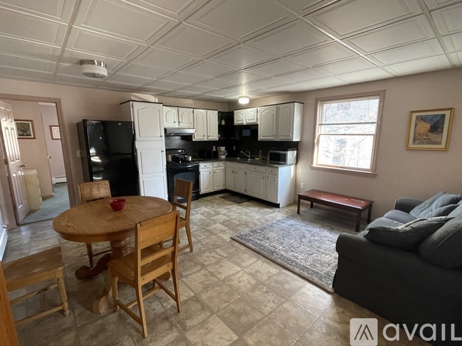 A kitchen with a table and chairs in the middle of the room.