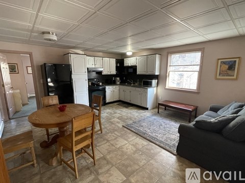 A kitchen with a table and chairs in the middle of the room.