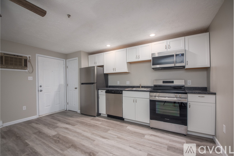 A kitchen with white cabinets and stainless steel appliances.
